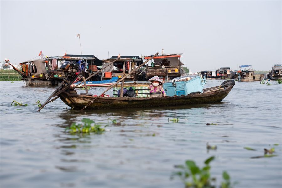 Small wooden boats and floating houses on the Mekong